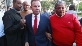 In this Jan. 11, 2019 file photos suspended Broward County Sheriff Scott Israel, center, leaves a news conference surrounded by supporters after new Florida Gov. Ron DeSantis suspended him, in Fort Lauderdale, Fla. 