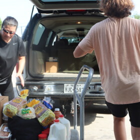 Volunteers load cars at the San Antonio Food Bank