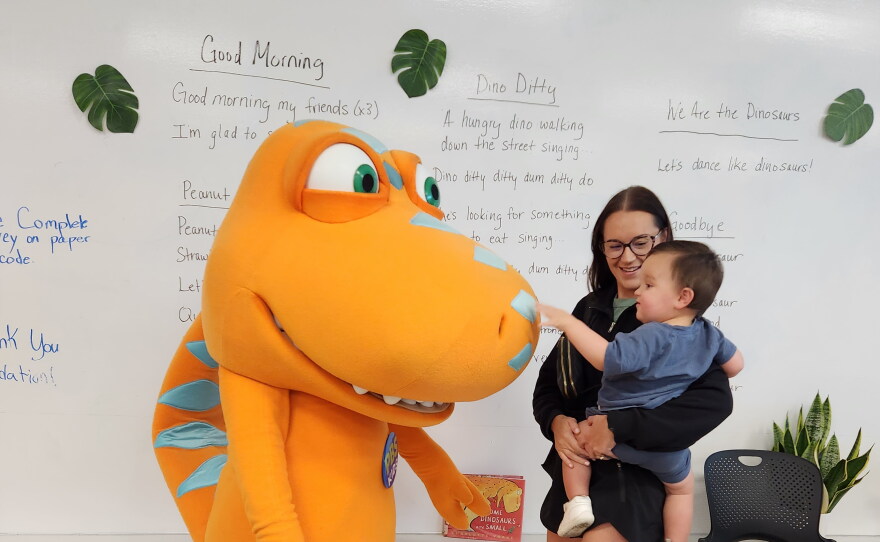 A todler held by a young woman meets Daniel Tiger