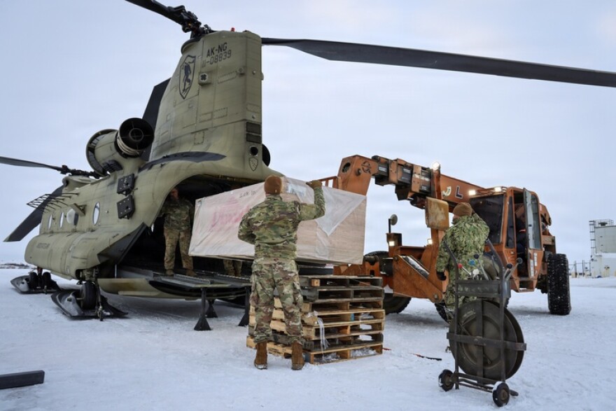 Members of the Alaska Air and Army National Guard, Alaska Naval Militia, and Alaska State Defense Force work together to load plywood onto a CH-47 Chinook helicopter in Bethel, Alaska on Nov. 2, 2025. The helicopter is bound for the villages of Napaskiak, Tuntutuliak, and Napakiak. The materials will help residents rebuild homes and restore community spaces damaged by past storms.