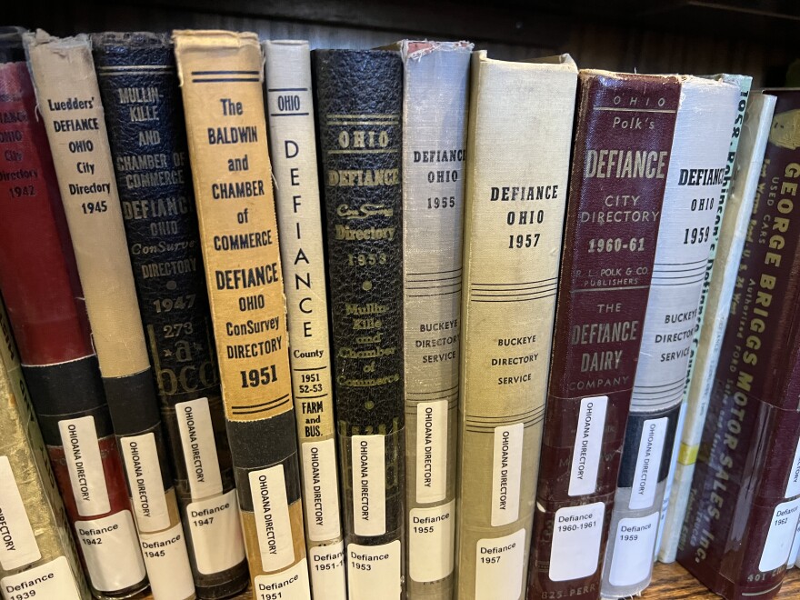 A shelve of books from the Defiance Public Library hold historical record of the city's directory.