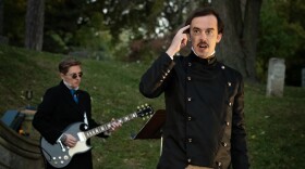 “Electric Poe” guitarist Meredith McGrade, at left, and actor R.H. Wilhoit perform on a hillside in Union Cemetery. The two collaborated during a series of rehearsals to create the score for the production.