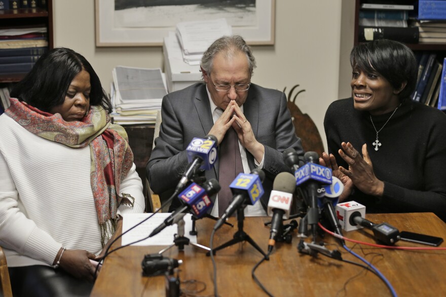 Kim Thomas (left), mother of Grafton Thomas, the man accused of stabbing five people at a Hanukkah celebration, and attorney Michael Sussman (center) listen as the Rev. Wendy Paige speaks about Grafton Thomas at a news conference in Goshen, N.Y., on Monday.