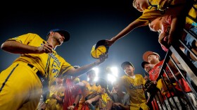 Retired St. Louis Cardinals pitcher Adam Wainwright signs autographs after making a surprise appearance on the mound during a banana ball game between the Savannah Bananas and the Party Animals on Friday, July 18, 2025, at Busch Stadium in downtown St. Louis.