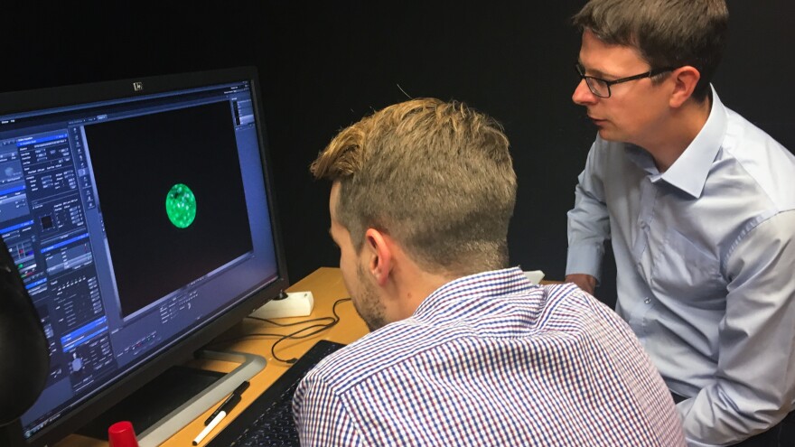 Fredrik Lanner (right) of the Karolinska Institute in Stockholm and his student Alvaro Plaza Reyes examine a magnified image of an human embryo that they used to attempt to create genetically modified healthy human embryos.