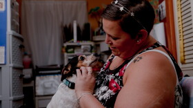 Kristina Nigro makes an eye contact with her dog Bailee. She was asked to pay back her unemployment benefits after receiving them for a year.