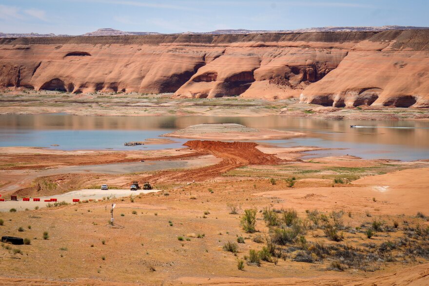 Crews move red dirt as part of a primitive ramp project to extend boat access in Bullfrog Bay, April 28, 2026.