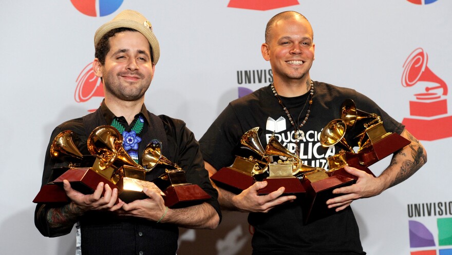 Eduardo Cabra Martinez, a.k.a. Visitante (left) and Rene Perez Joglar, a.k.a. Residente of Calle 13 pose with their Latin Grammy Awards.