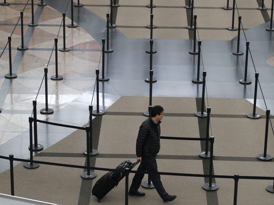 A traveler finds no line to stand in at a security checkpoint at Denver International Airport on Friday.