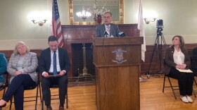 Senate President Dominick Ruggerio, at the podium during a March 2024 news conference, wants to elevate Democratic Whip Val Lawson, far left, over Ryan Pearson, left.