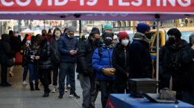 People wait in line to receive a COVID-19 test on Tuesday in New York. The U.S. recorded more than 1 million COVID-19 cases on Monday.