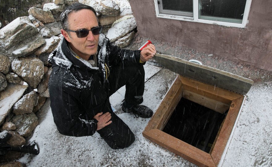 Drew Miller, a self-described prepper, is the CEO of Fortitude Ranch, a development for like-minded people in a remote quarter of the Colorado Rockies. Here, he has opened a hatch to a living space below a guard position on the ranch.
