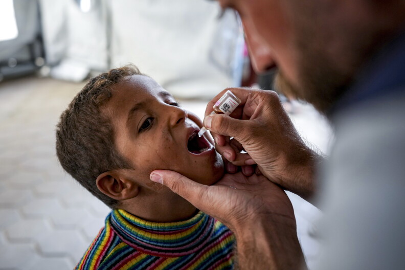 A health worker administers a polio vaccine to a child at a hospital in Deir al-Balah, central Gaza Strip.