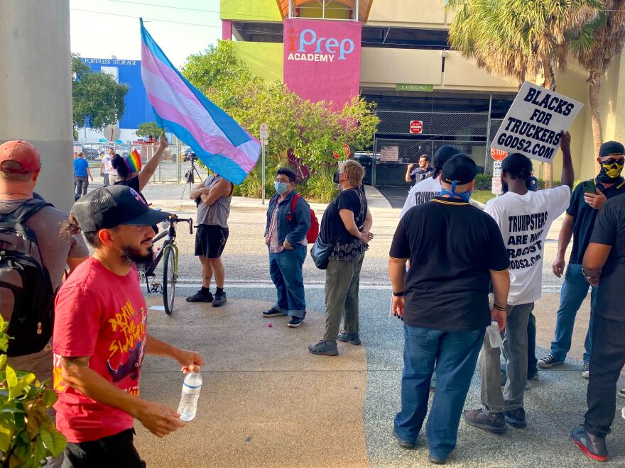 A person waves a transgender rights flag outside the Miami-Dade County School Board building on September 7, 2022 during a contentious debate on whether the district should designate October as LGBTQ History Month.