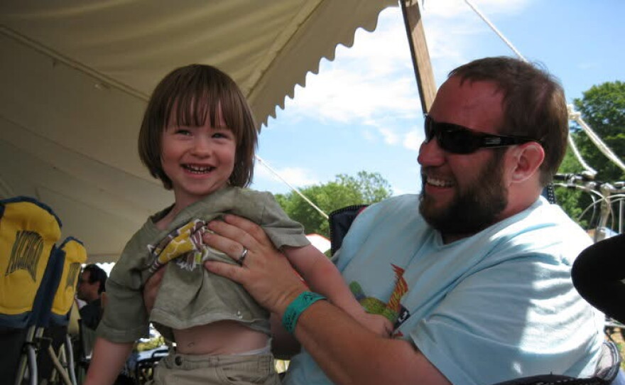 Kam Culbertson holds his then-2-year-old son at Blissfest in 2010. Culbertson said the festival has always been fun for his whole family.