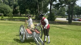 Historical reenactors loading a cannon at the Backcountry Revolution Trail opening ceremony.