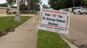 A sign outside the East Baton Rouge Parish School System office opposes Amendment 2, which would create a separate school district for the new city of St. George, on May 11, 2026.