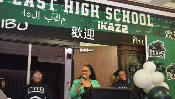 Superintendent Jennifer Collier celebrates East High School's centennial anniversary with a crowd of student, alumni and staff.
