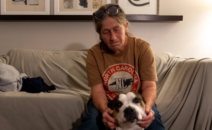 Theresa Sanchez and her bulldog Daisy in a hotel room paid for by FEMA.