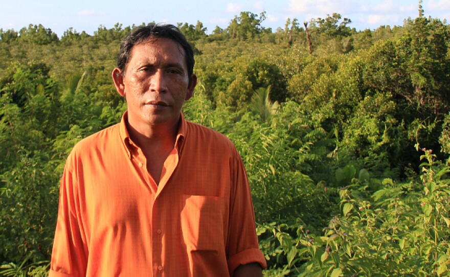 Rignolda Jamaluddin, a local marine scientist, stands in front of the mangrove forests of North Sulawesi that he has worked to rebuild over the past two decades. Part of his strategy included educating villagers on ways they would benefit from not cutting down the trees, such as making alcohol, sugar and furniture from the trees.