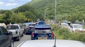 Photo description: Emergency vehicles gather at Brewers Bay on St. Thomas.