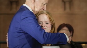 President Joe Biden hugs Sandy Hook survivor Jackie Hegarty, who introduced him, during an event in Washington, Wednesday, Dec. 7, 2022, with survivors and families impacted by gun violence for the 10th Annual National Vigil for All Victims of Gun Violence.