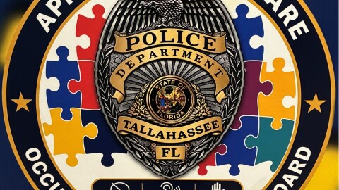 This TPD decal has a badge and the words "Approach with care. Occupant with autism on board."