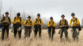 Members of the Gannett Glacier Fire Crew takes notes during a fire training scenario near Palmer on Thursday, April 29, 2018. (Casey Grove/Alaska Public Media photo)