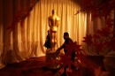 Workers install an Oscar statue Saturday, March 14, 2026, at the Dolby Theatre in Los Angeles, in preparation for Sunday's 98th Academy Awards ceremony.