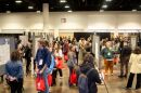Attendees mingle during a poster show happy hour where anthropologists present their research and work in the main exhibit hall of the conference.