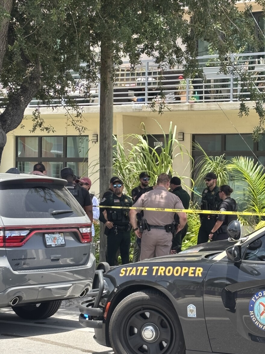 Florida Highway Patrol troopers mingle with Palm Beach County Sheriff's office, who are helping to secure a standoff initiated by a U.S. Immigration and Customs Enforcement traffic stop on July 9, 2026.