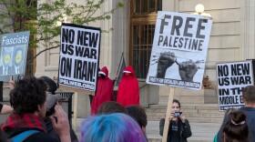 Demonstrators holding anti-war signs