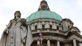 A staute of Queen Victoria stands in front of the union flag at Belfast City Hall in Belfast, Northern Ireland, hoisted to mark the Duchess of Cambridge's 31st birthday.