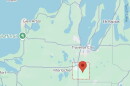 A map shows a pin dropped within a red box near Interlochen and Traverse City.