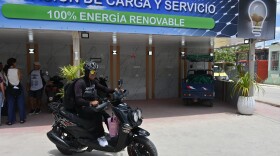 A motorcyclist leaves after recharging his electric bike at a charging station in Santa Clara, Cuba, Saturday, May 2, 2026. (AP Photo/Jorge Luis Banos)