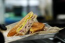 Cubans Be Like restaurant makes a Miami-style cuban sandwich with Cuban bread, roasted pork, Serrano ham, pickles and mustard.