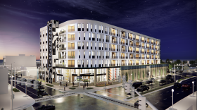 A rendering of the proposed Houndstooth apartment building shown from the intersection at Monticello and Brambleton avenues. The plan includes the preserved façade of the defunct Greyhound station on the first floor.