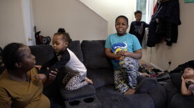 Eliza Carey (left) sits with her children. "This (expansion with monthly payments) is gonna make a big difference for a lot of families," she said.