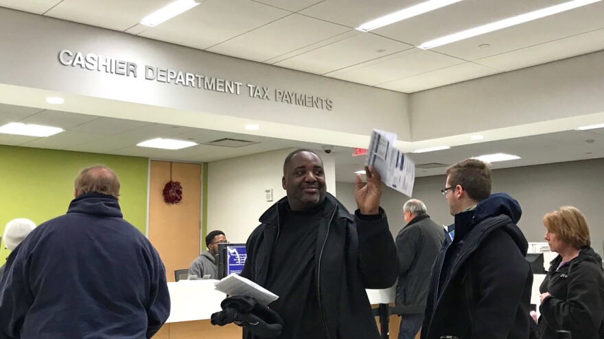 Residents line up to pay their property tax bills to the Cuyahoga County Treasurer on Thursday, one day before the county's final tax collection day of the year. [Adrian Ma / ideastream]