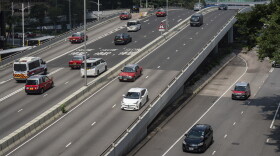 Cars move on an overbridge outside government headquarters in Hong Kong's Admiralty district, Saturday, Sept. 28, 2024. (AP Photo/Chan Long Hei)