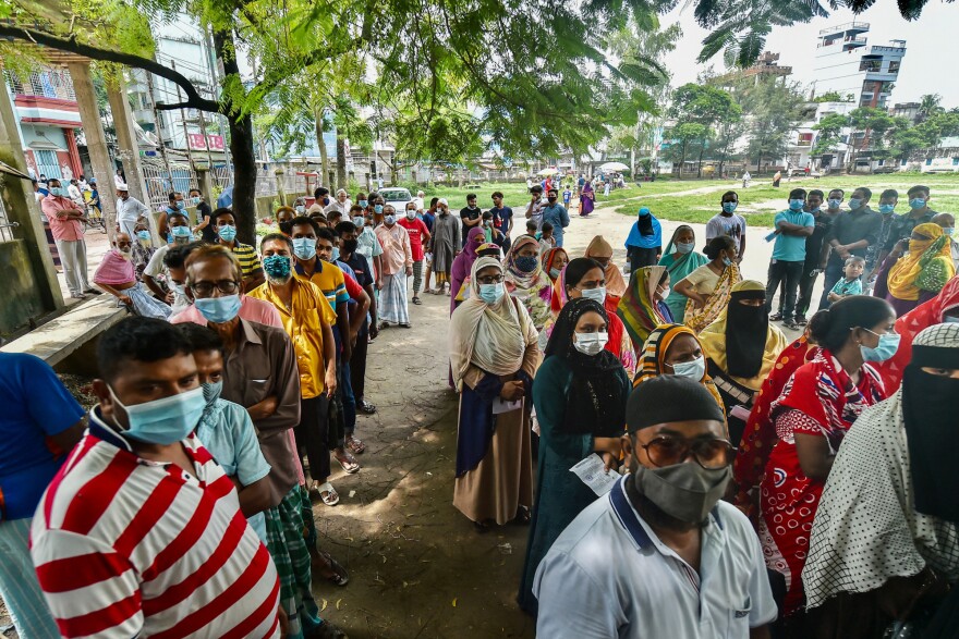 Bangladeshis queue up (and mask up) for their coronavirus vaccine.