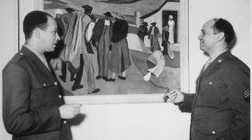 Romare Bearden (right) discussing his painting "Cotton Workers" with Pvt. Charles H. Alston, his first art teacher and cousin, in 1944.