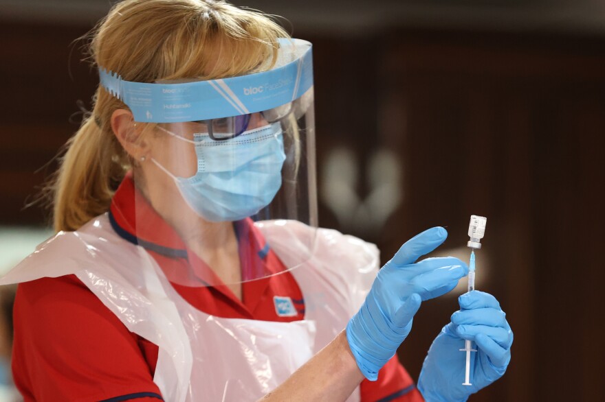 A nurse prepares to inject residential care home staff with the Pfizer/BioNTech COVID-19 vaccine in Belfast, Northern Ireland.