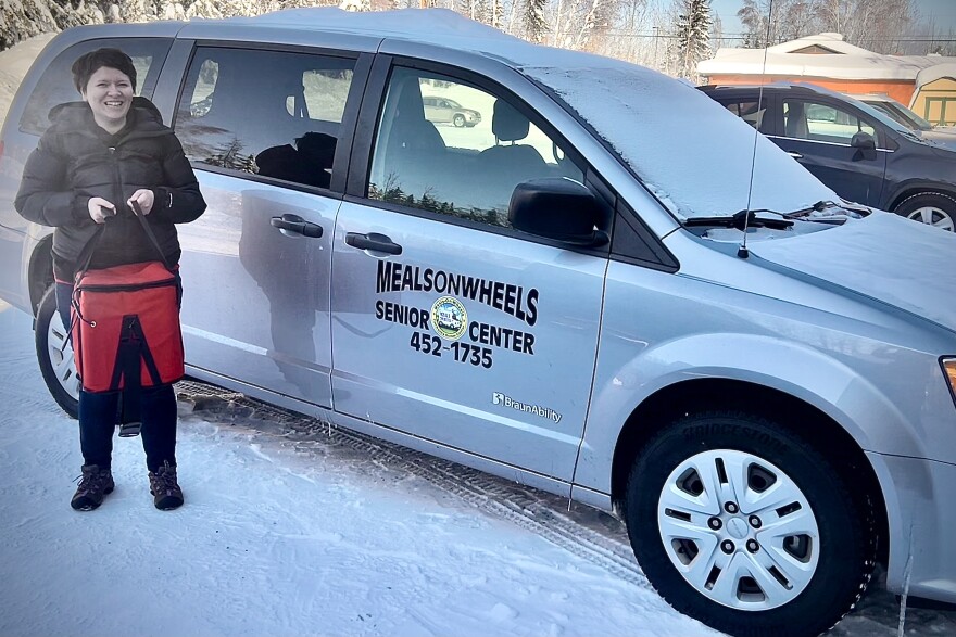 Fairbanks Senior Center Meals on Wheels volunteer coordinator Ashley Edginton carries a tote of food for a delivery run March 4, 2026. Edginton’s delivery list includes several food-insecure veterans. But as a group, she said, they can be really hard to reach.