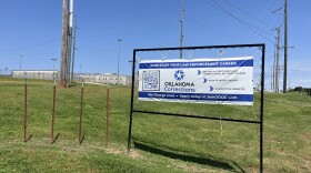 A road sign advertising correctional officer vacancies sits in front of the Lexington Assessment and Reception Center on May 22, 2024.