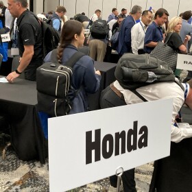Sellers sign up for five-minute meetings with different car makers and manufacturers at the Southern Automotive Conference in Huntsville, Alabama, on October 7, 2025.