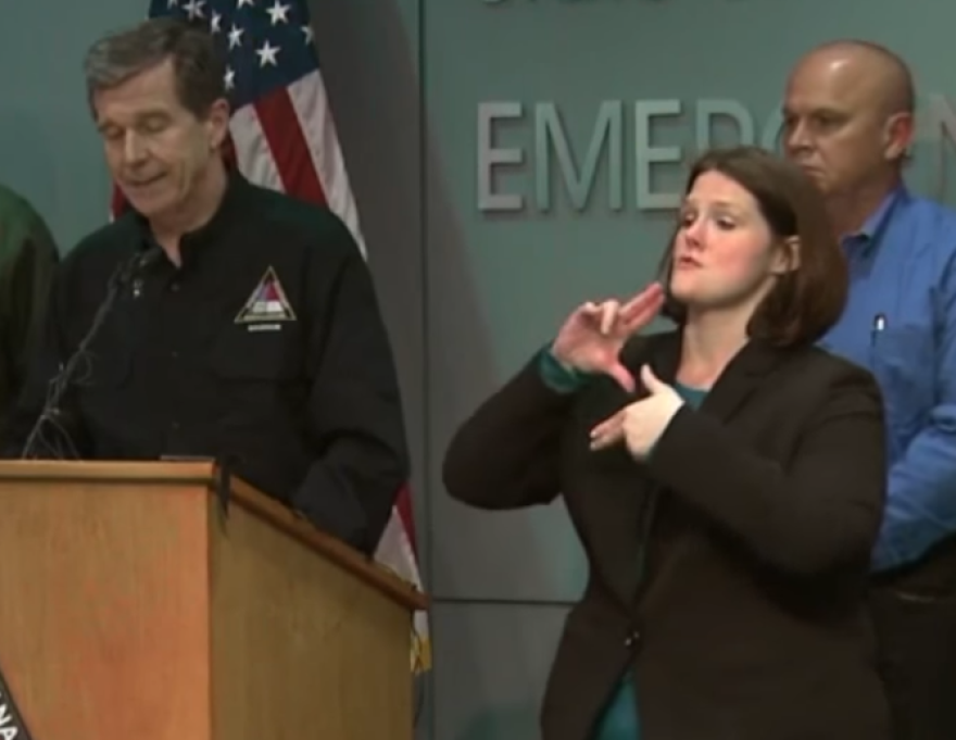 Monica McGee translates Gov. Roy Cooper's remarks during a Hurricane Florence press conference.