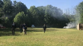 Safety officials check the exploded cars before IUPUI students investigate the wreckage at Eagle Creek Pistol Range on Friday, June 14, 2019.