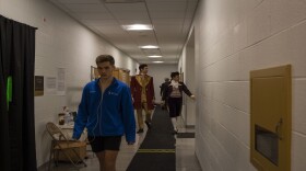Dancers stroll down the hall as they head to the stage.