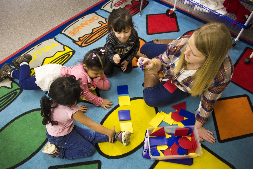 Teacher Sarah Ross and students (from left to right) Ximena, age 4, Yareli, age 3, and Kendra, age 2 at the Indiana Migrant Preschool Center, a free preschool for migrant children ages 2 to 5. The school teaches students in English and Spanish with the goal of preparing migrant children for kindergarten, wherever it may be.